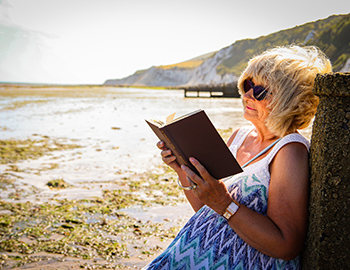 Relaxing with a book on Holywell Beach